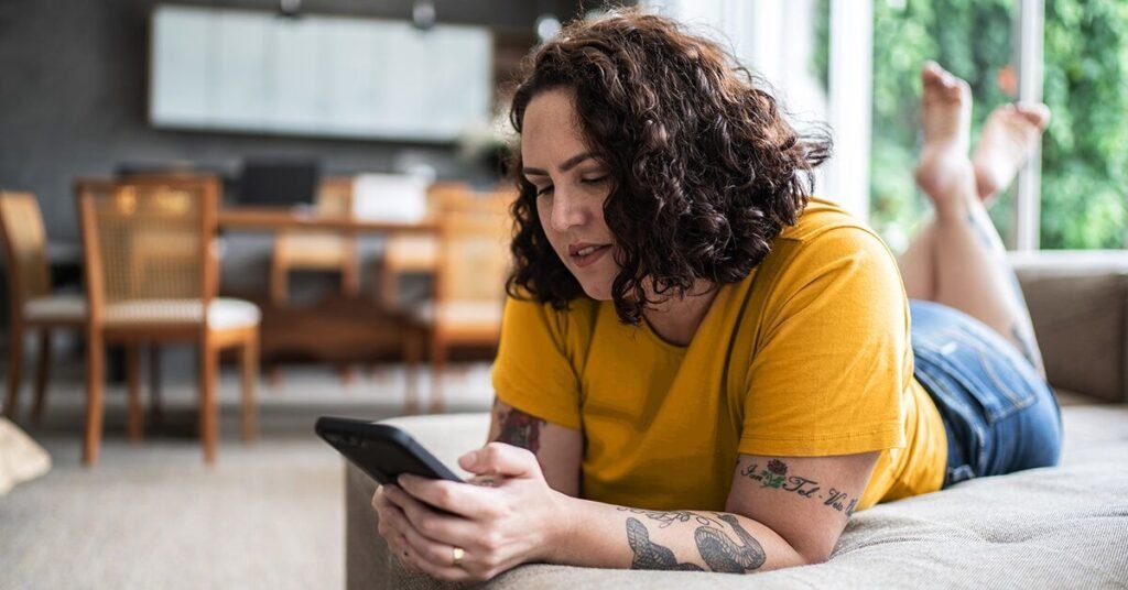 female-with-phone-on-sofa-1200-628-facebook-1200×628-1