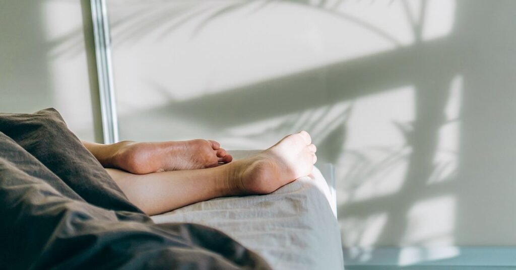 woman-feet-sleeping-in-bed-facebook